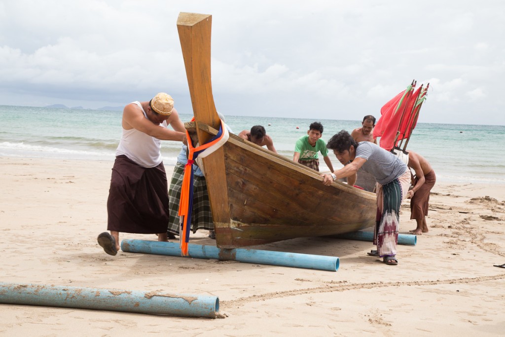 Fishermen Push a Longtail Boat to Shore Near Krabi, Thailand