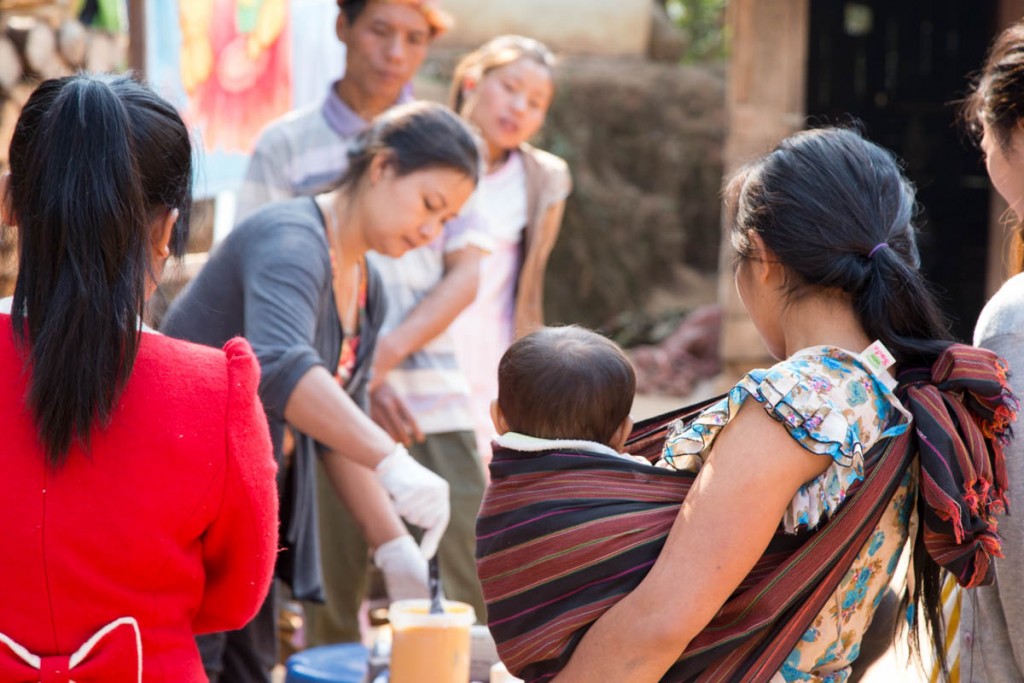 A Young Mother Watches the Soap Making Process