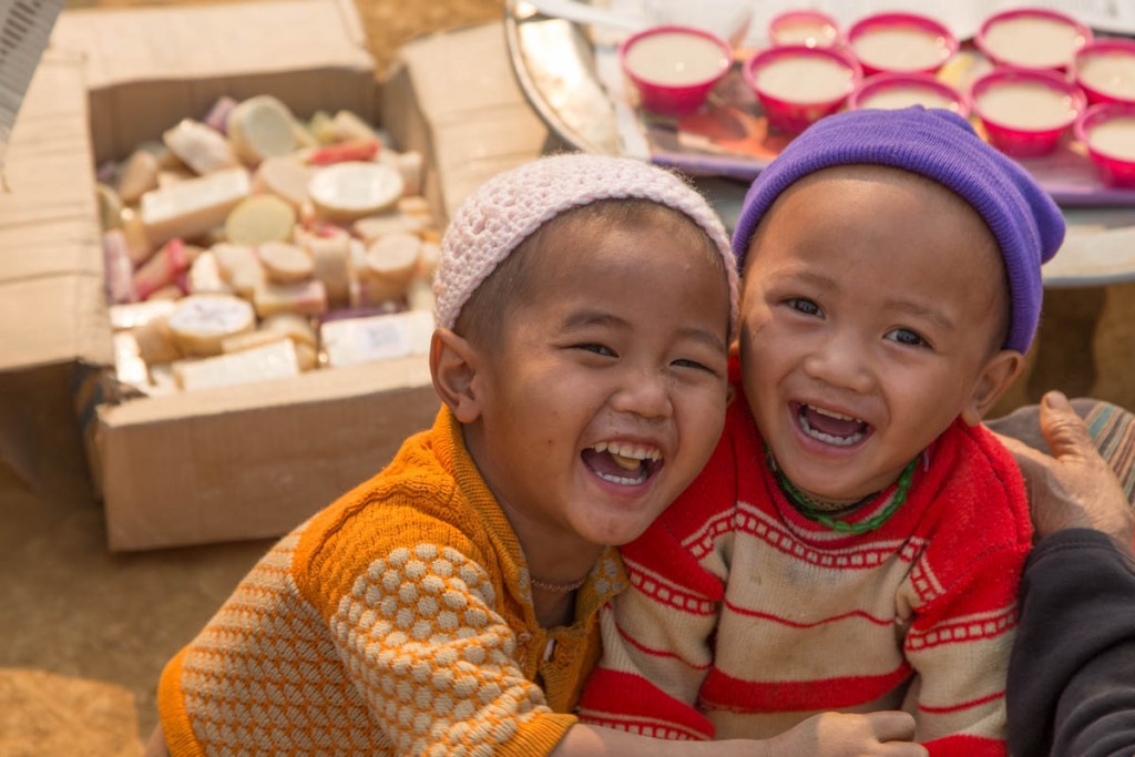 Children Laughing in Front of Boxes of Soap
