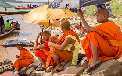 Photo: Monks on Mekong River Watching Dragon Boat Races