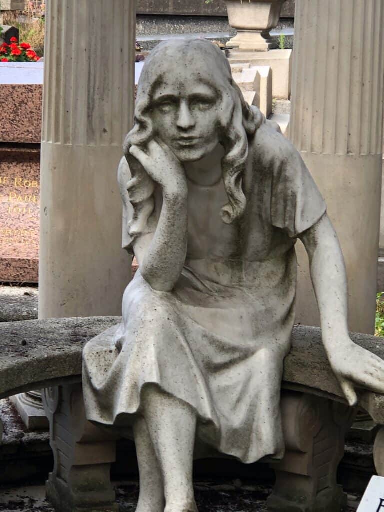 A child statue at Pere Lachaise Cemetery