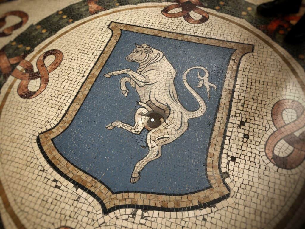 Spin on the bull mosaic in the Galleria Vittorio Emanuele for good luck 