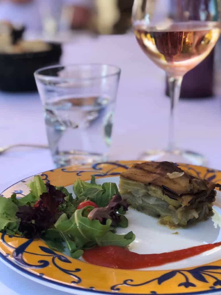 A starter salad with a glass of rose wine served in a winery near Les Baux-de-Provence