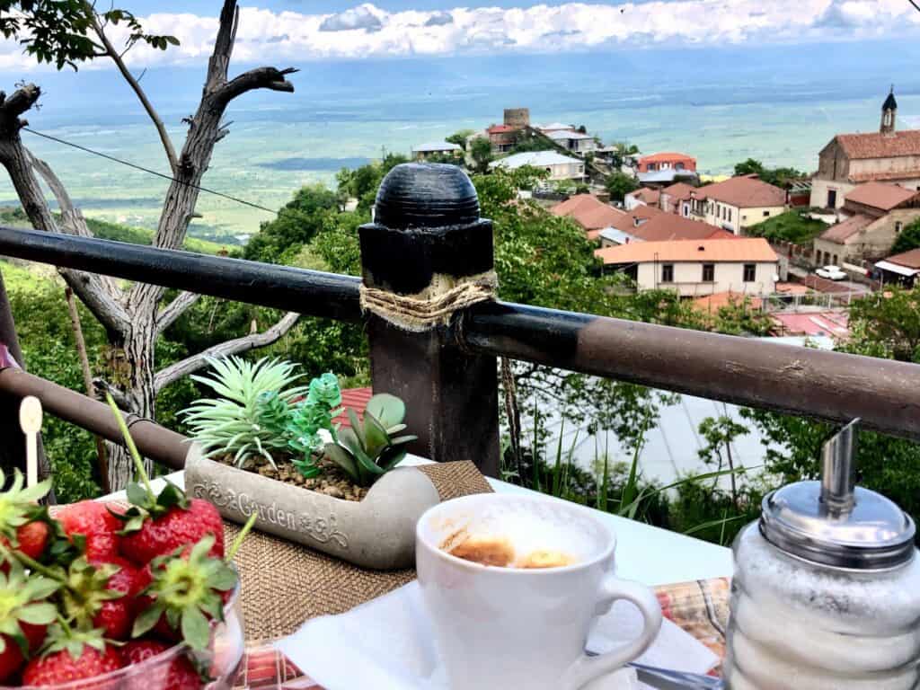 Coffee and fresh strawberries with a view of the town of Sighnaghi Georgia