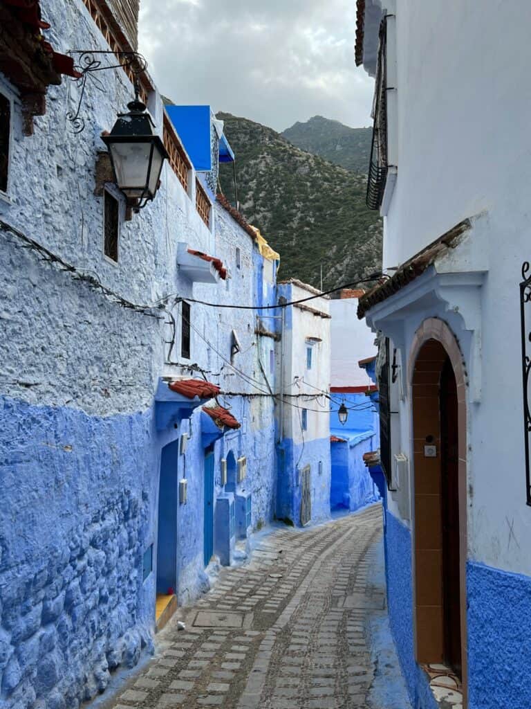 A quiet cobbled street with blue houses in Chefchaouen 