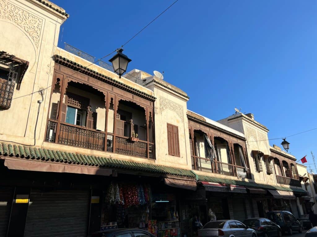 Old Balconied Buildings Found In The Jewish Quarter in Fes. Against a bright blue sky
