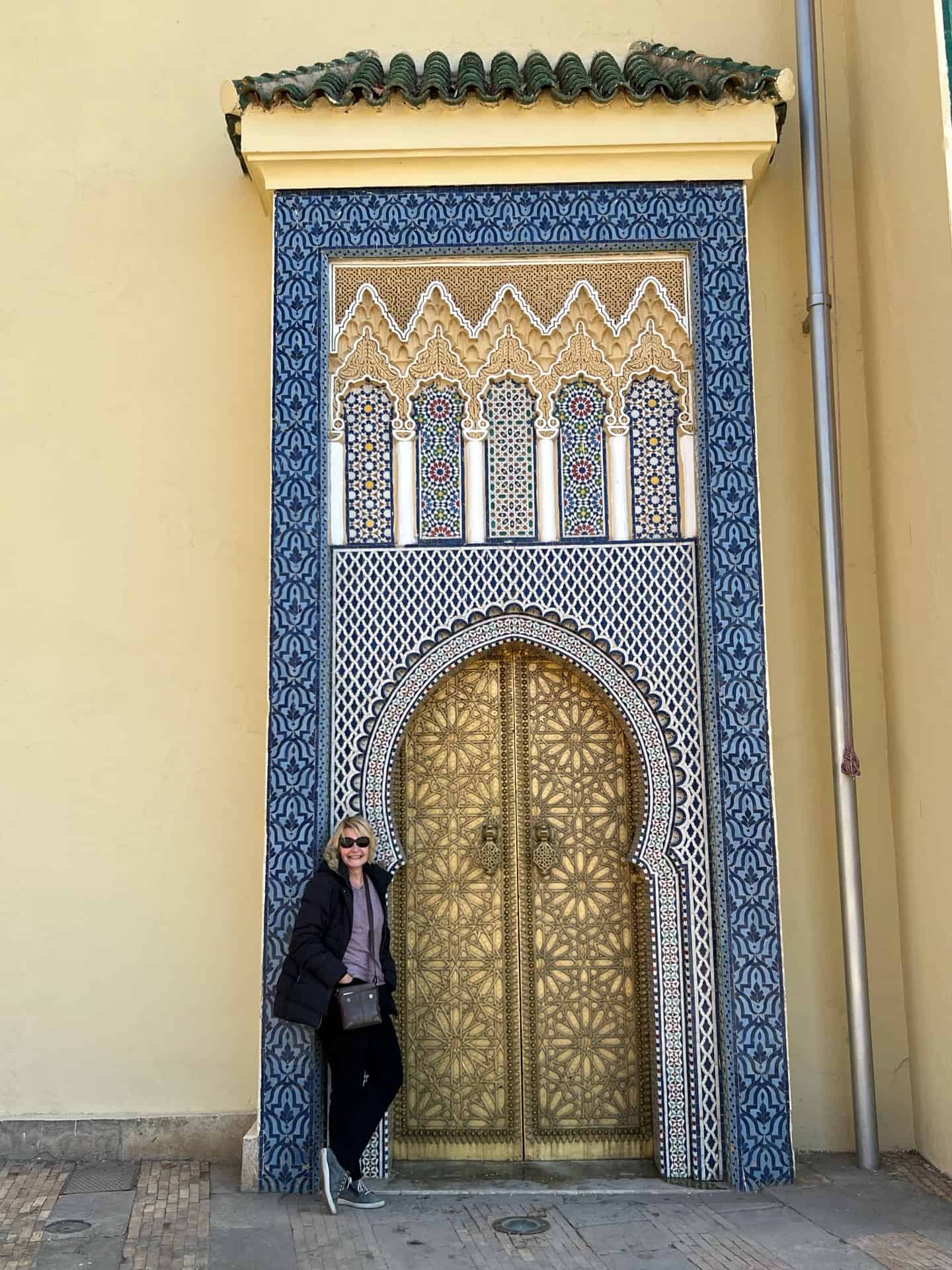Beautiful mosaic door made with blue and gold outside the palace in FEZ