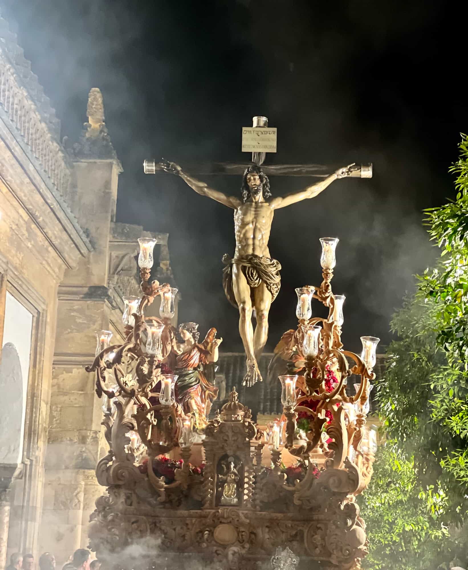 Jesus one a cross being carried to the Mezquita in Cordoba 

