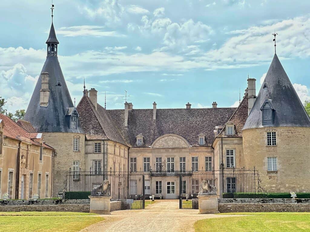 The exterior of Château de Commarin  with its two pointy towers 
