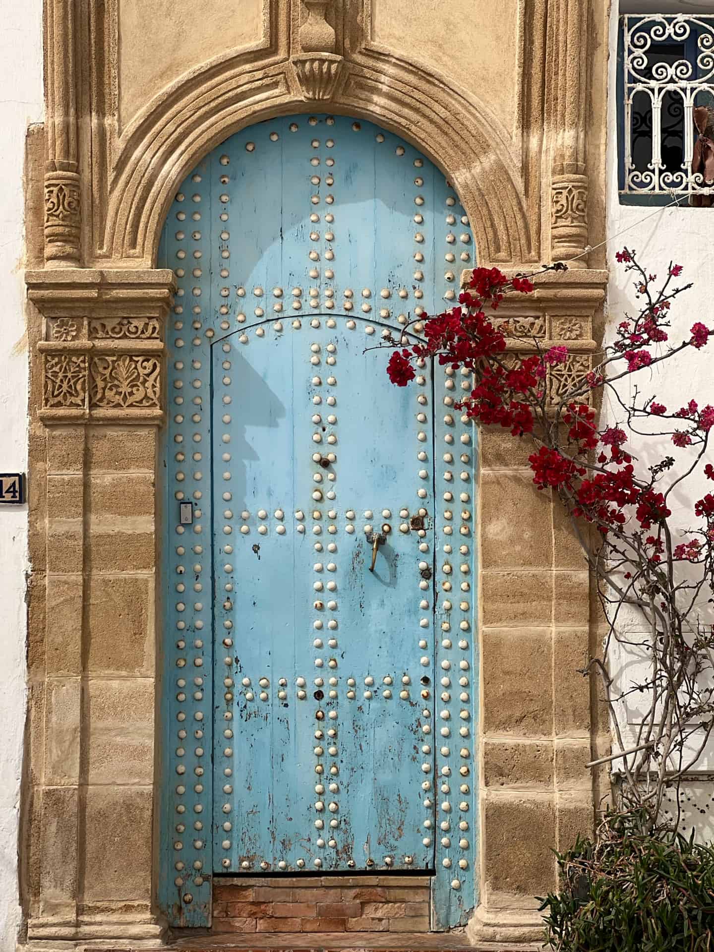 A blue door with red flowers
