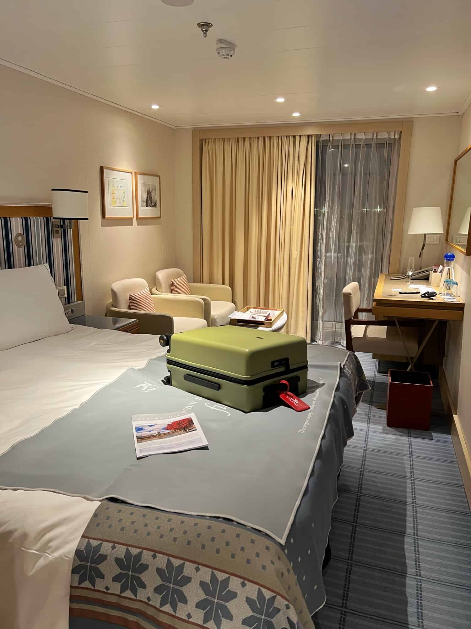 The Cabin showing bed with a small green suitcase on top