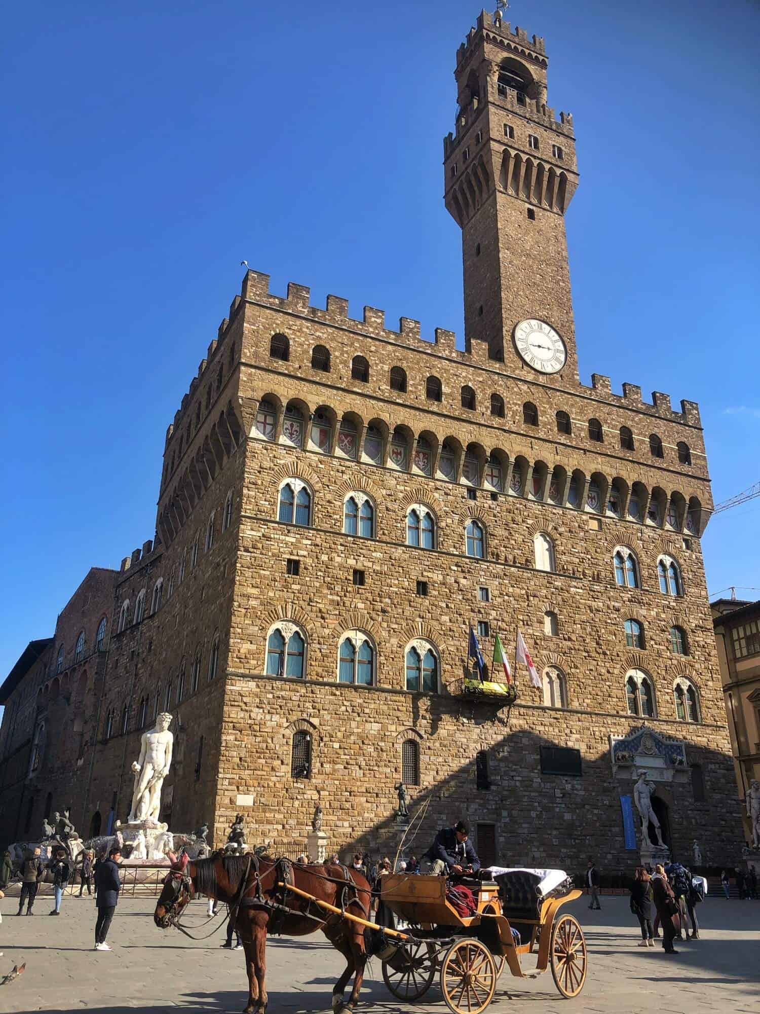 The Palazzo Vecchio in the Piazza della Signoria with a horse and cart in the foreground 