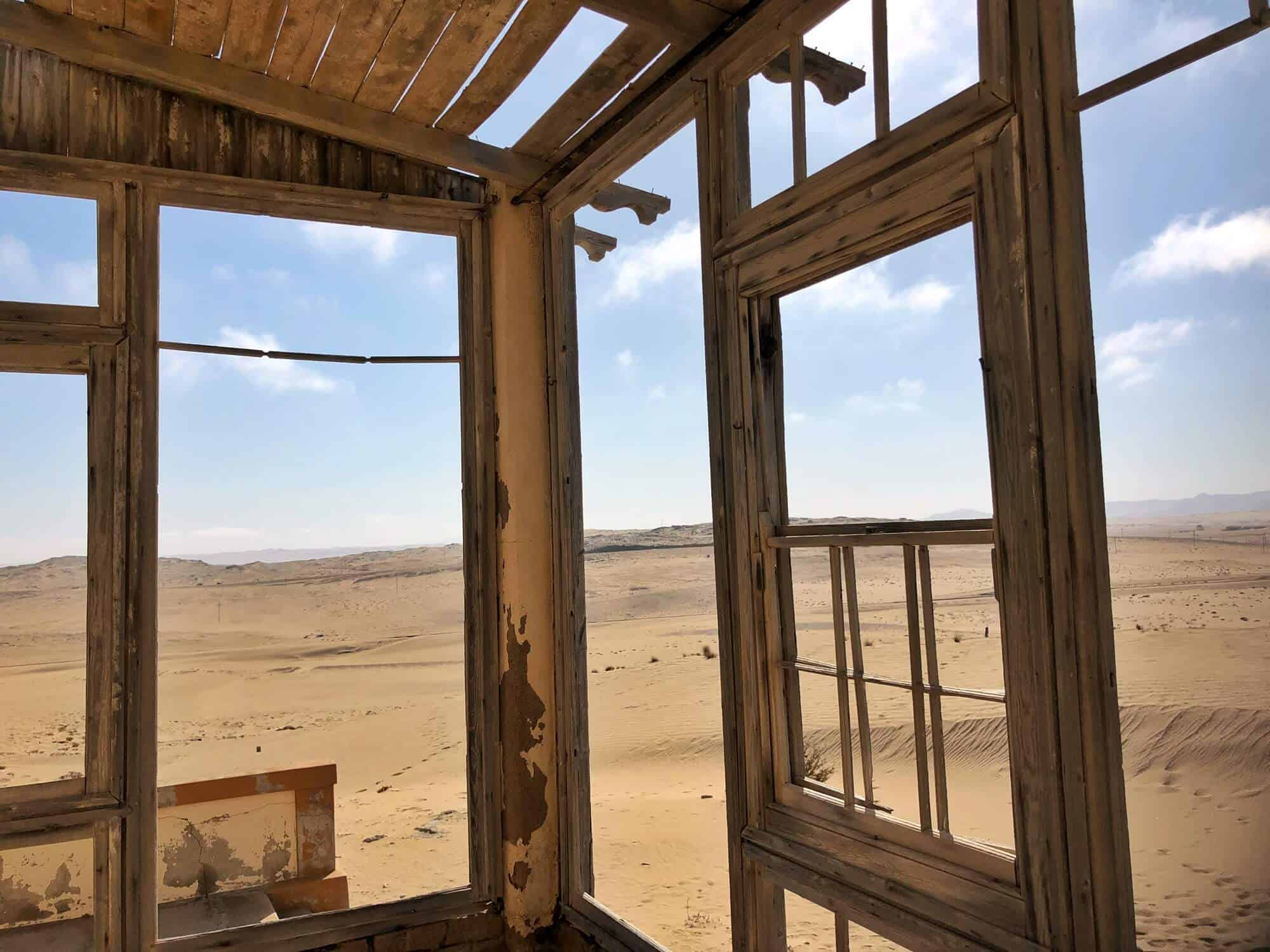 Looking through broken window and crumbling sill at the 
Namib desert 