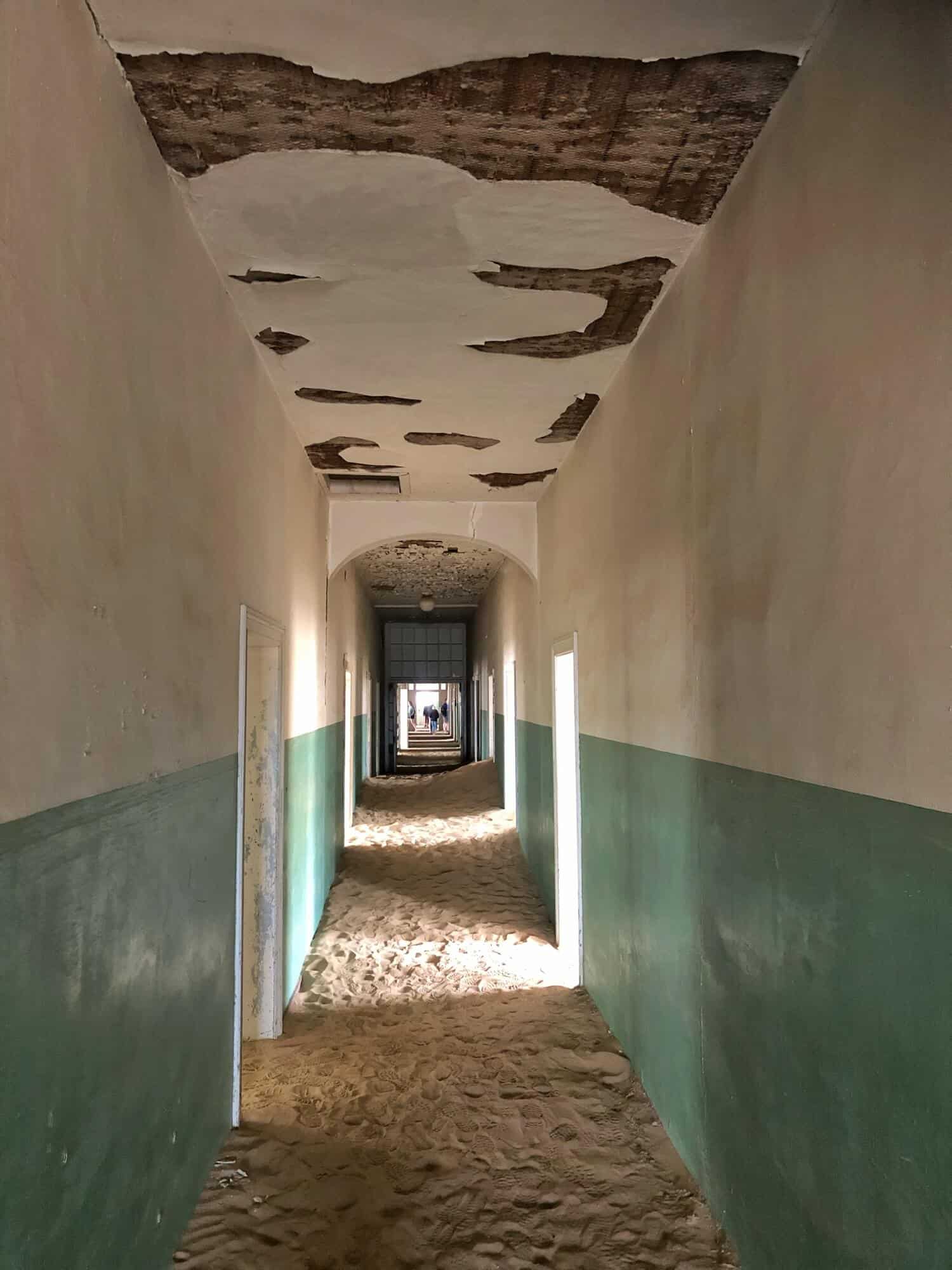 The sandy corridor of the hospital with green and white walls. 