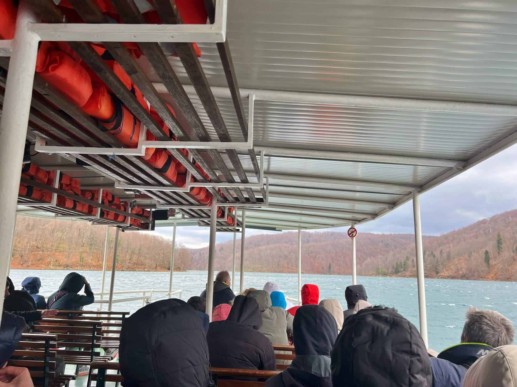 People on board the boat crossing the lake at Plitvice Lakes