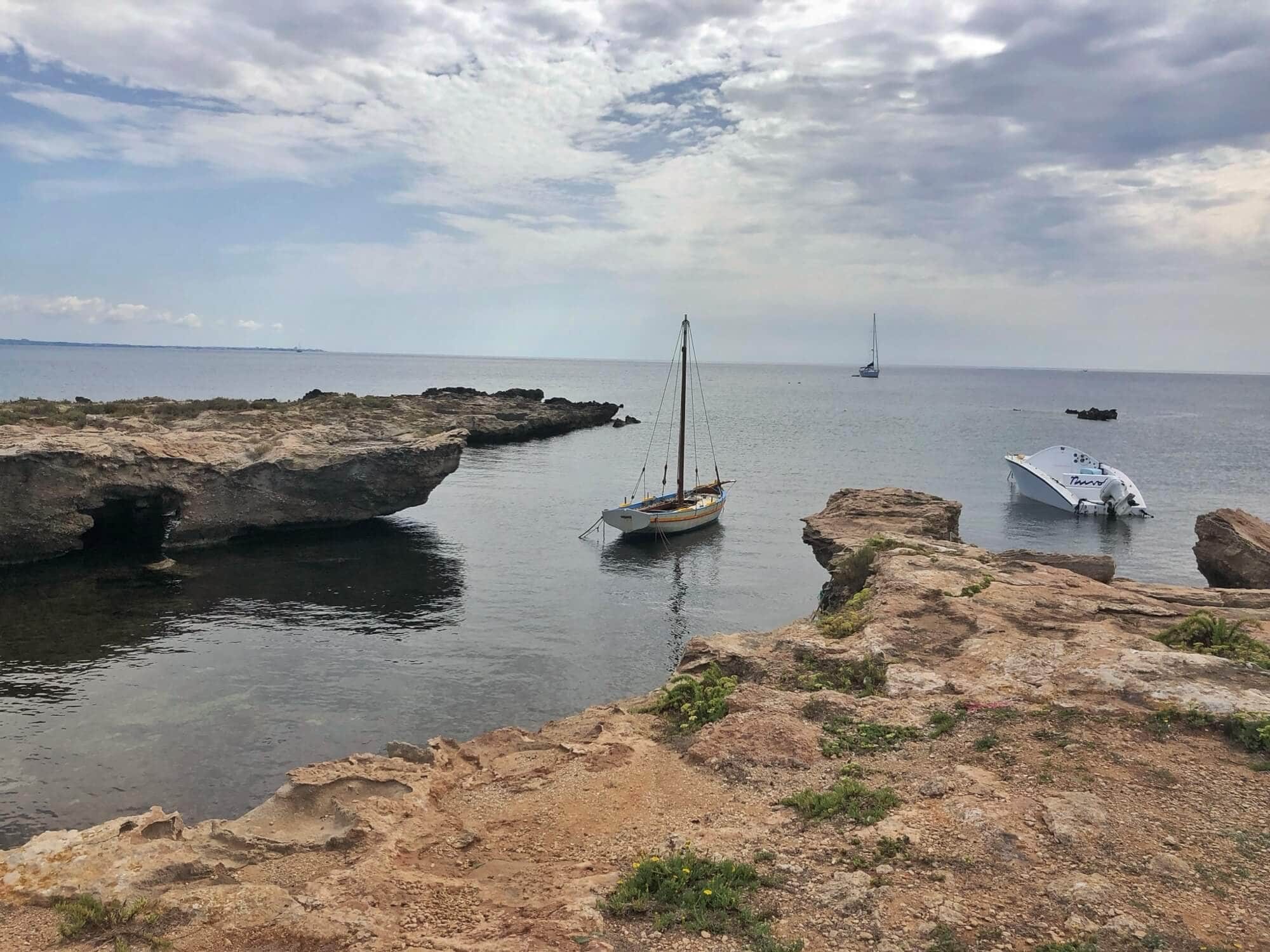 Rocky inlet with two small boats 