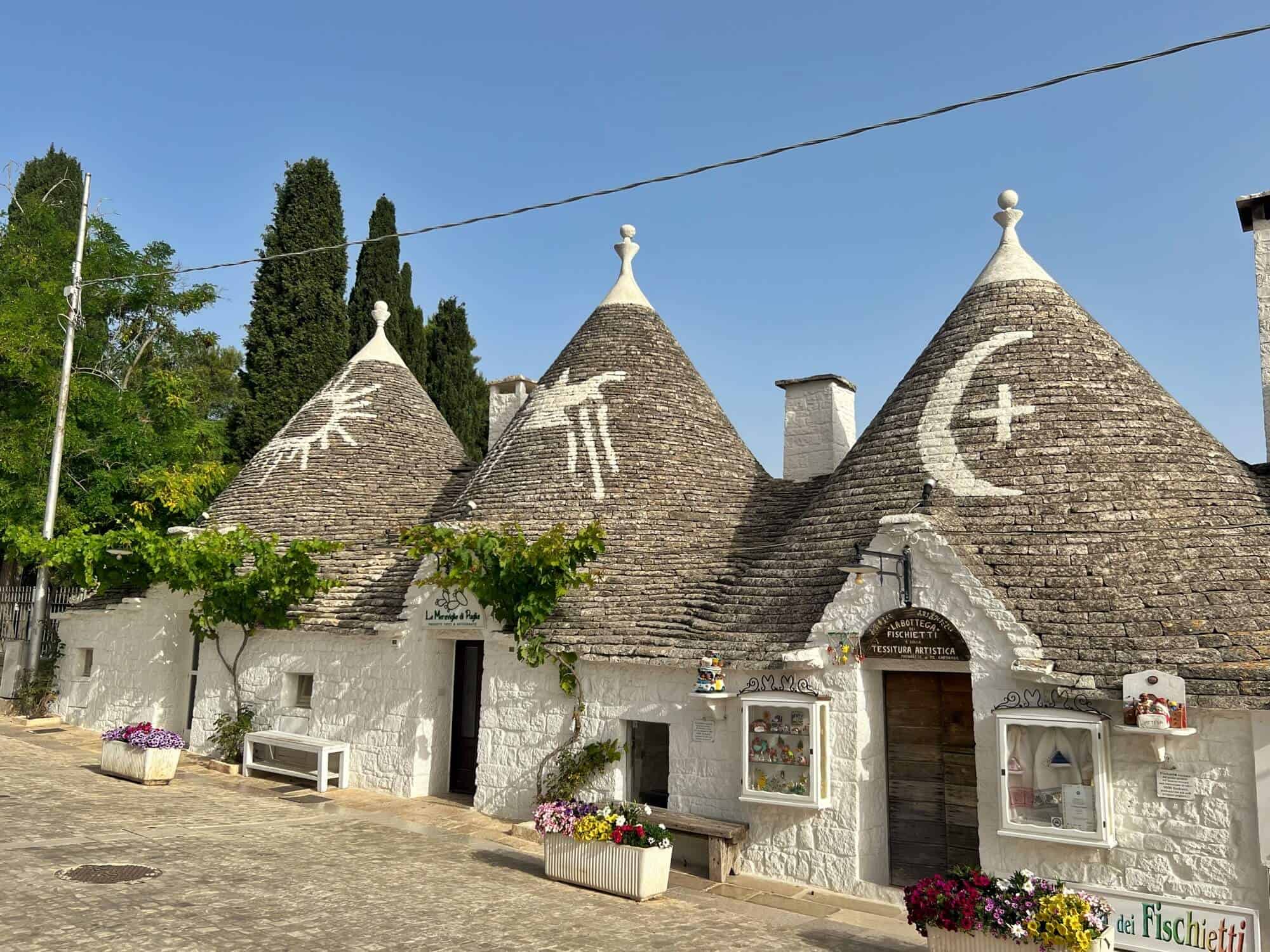 Trulli Houses in Alberobello with typical white walls, cone roofs and symbols. 