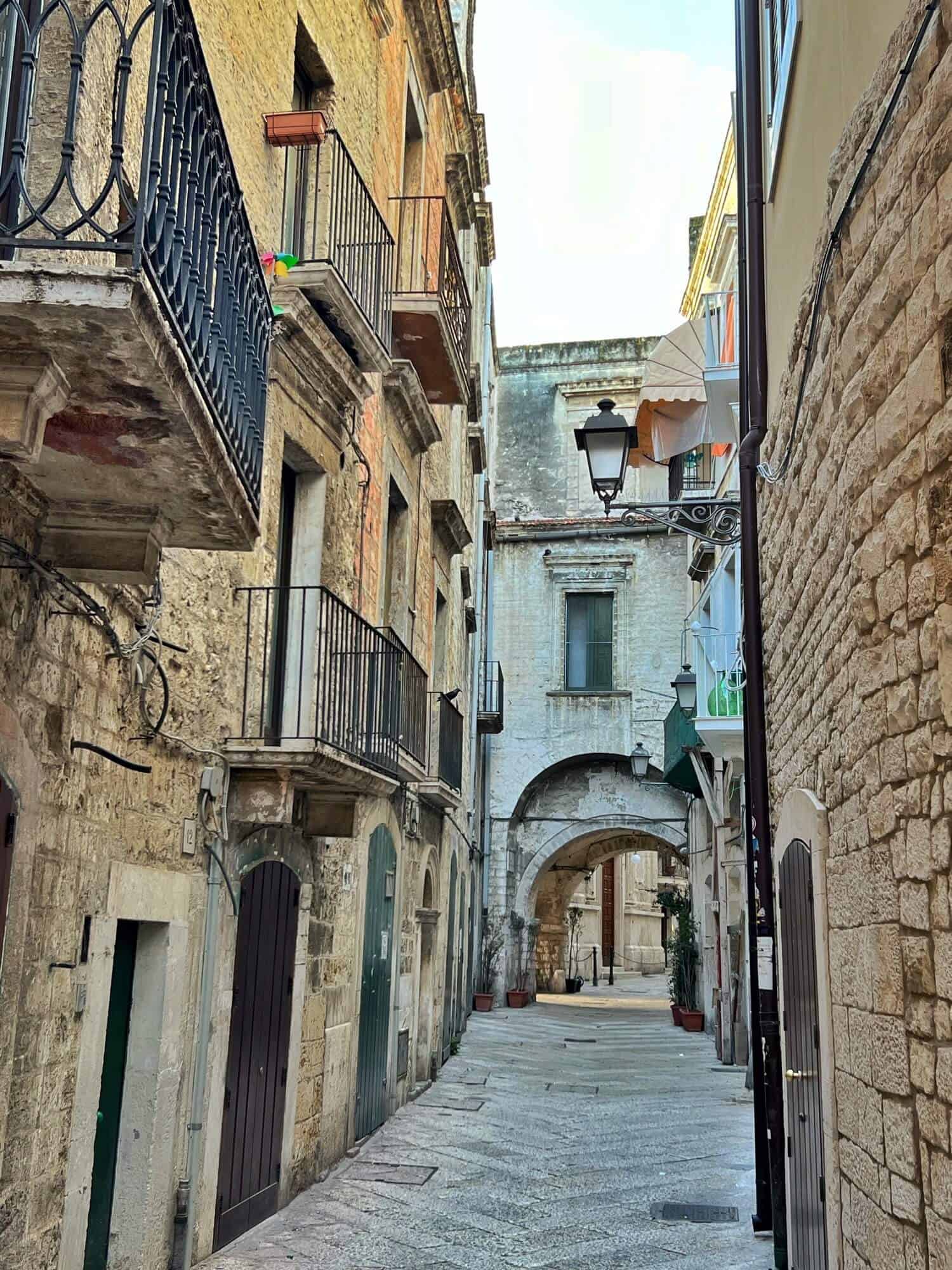 Empty narrow street lined with houses with balconies 