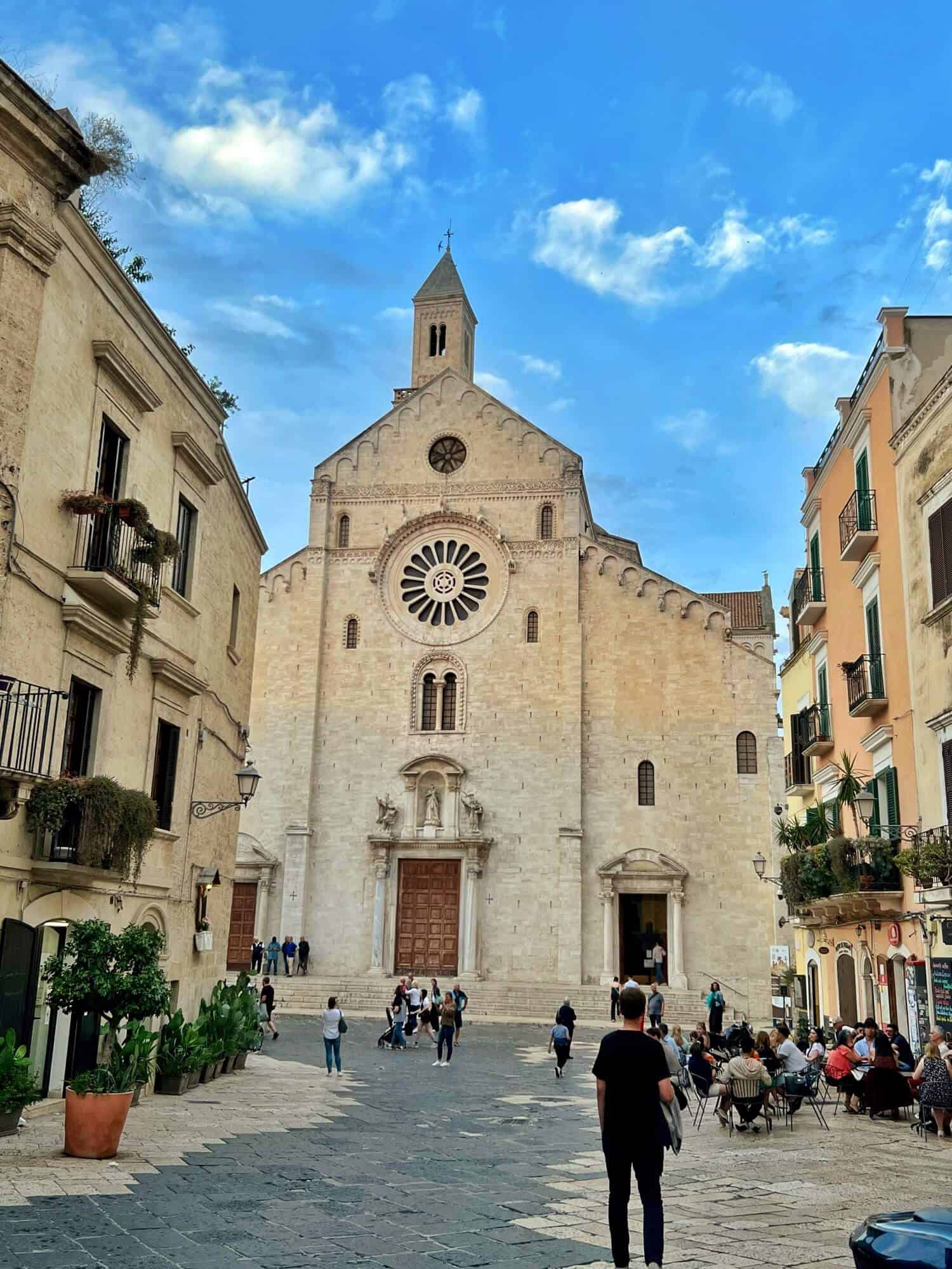 The facade of Bari Cathedral with its bell tower and large rose window 