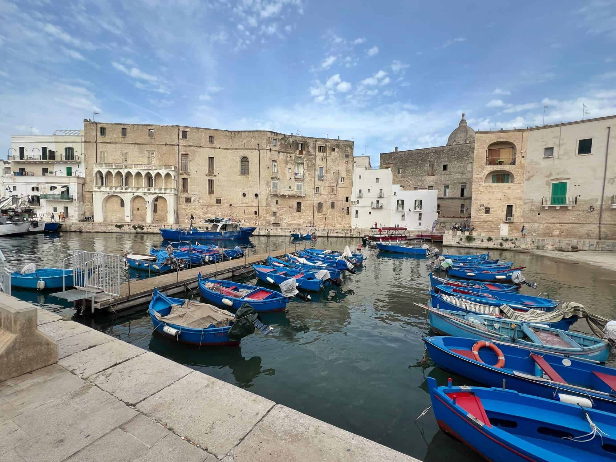 blue fishing boats in the old port of Monopoli 