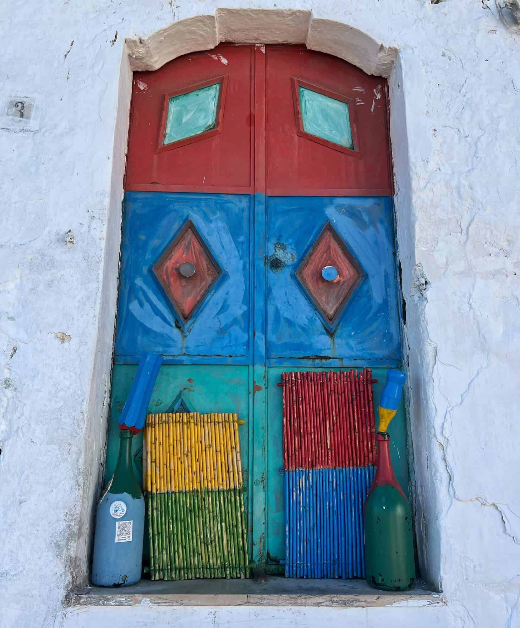 Brightly coloured painted door in red blue and green