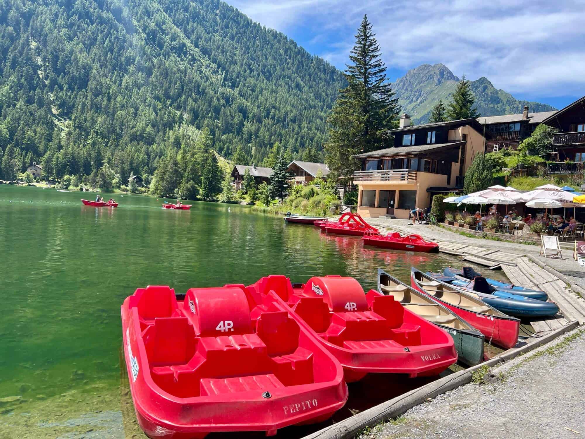 Bright red pedalos, canoes and kayaks on the lake at Champex Lac