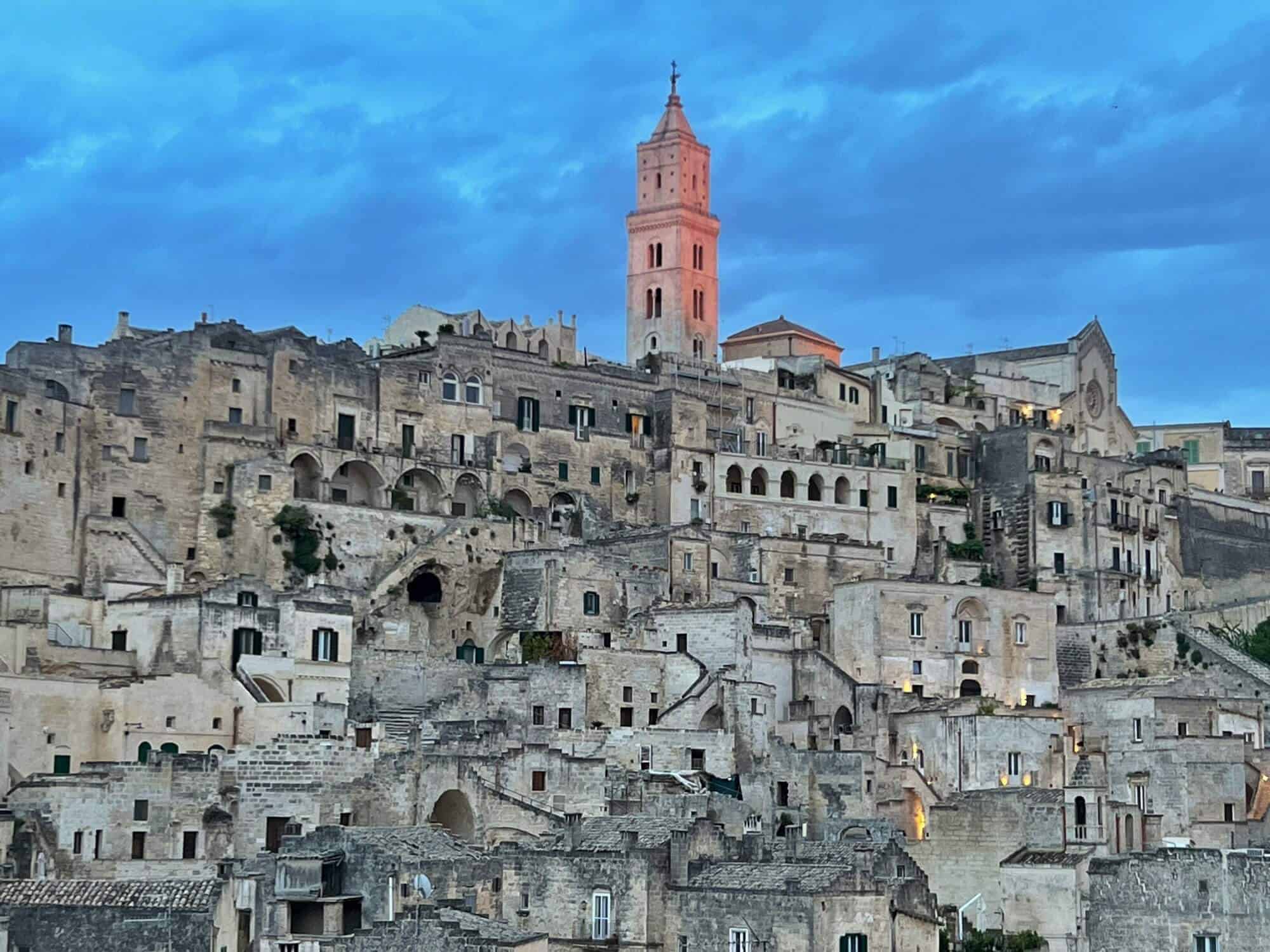 Matera by night. Church tower turns pink at sunset 