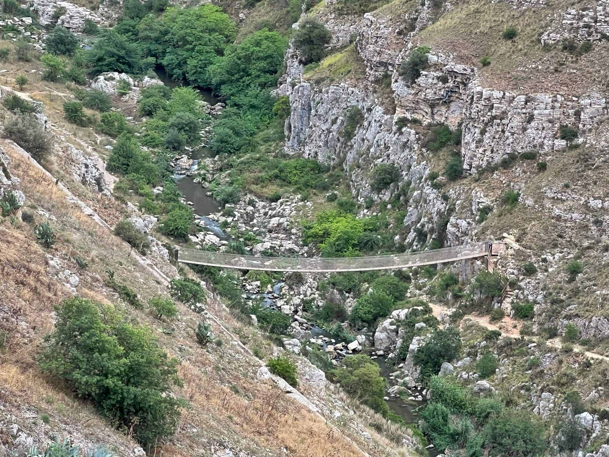 A walking suspension bridge across the gorge in Matera 