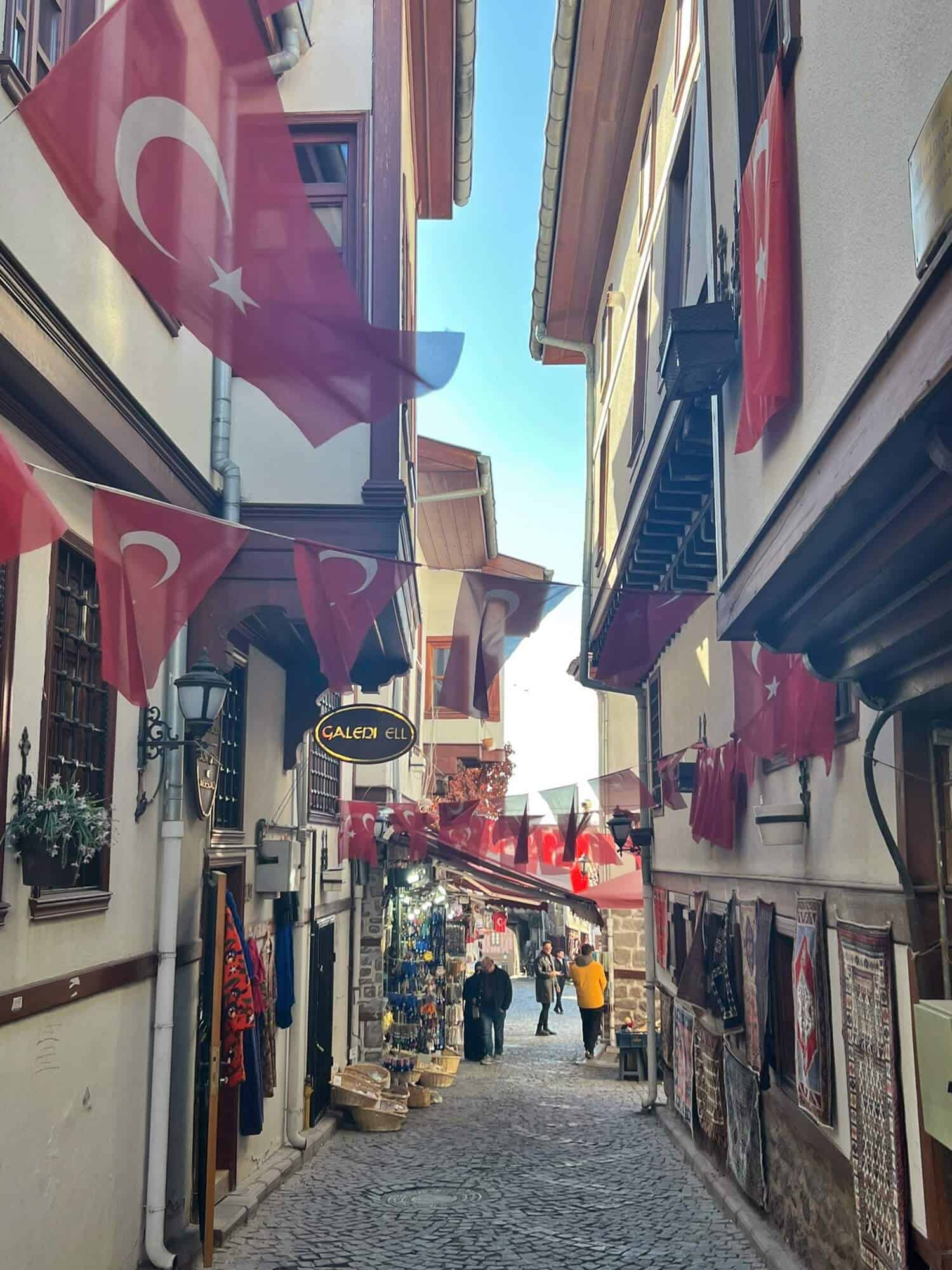 Shopping street in Ankara's citadel lined with Turkish flags 