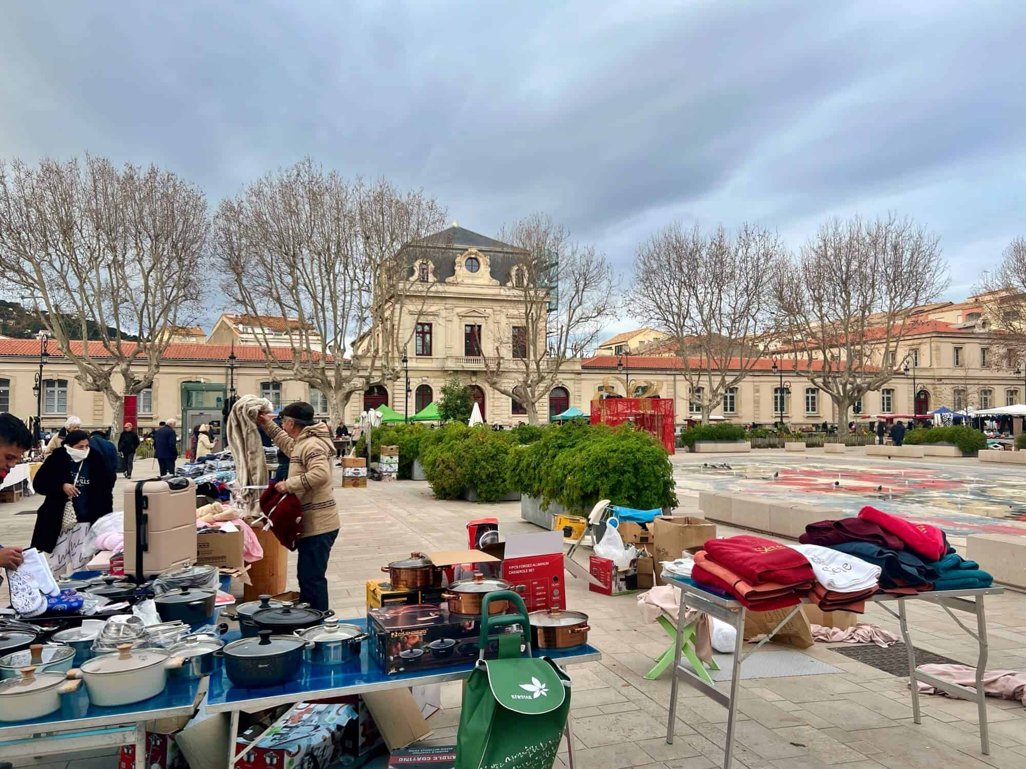 market stalls selling towels and saucepans 