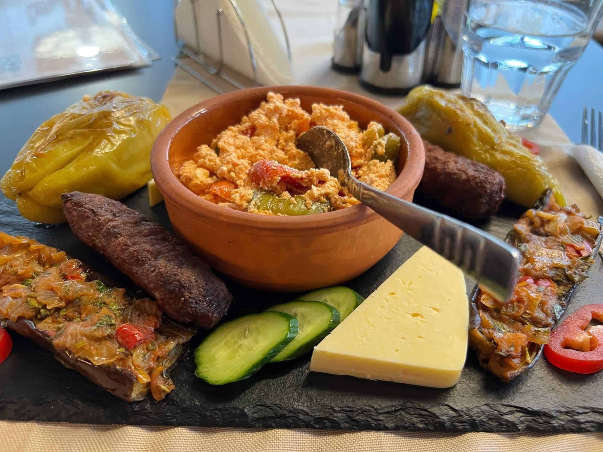 An Albanian snack with dips, cheese, chilies and egg plant 