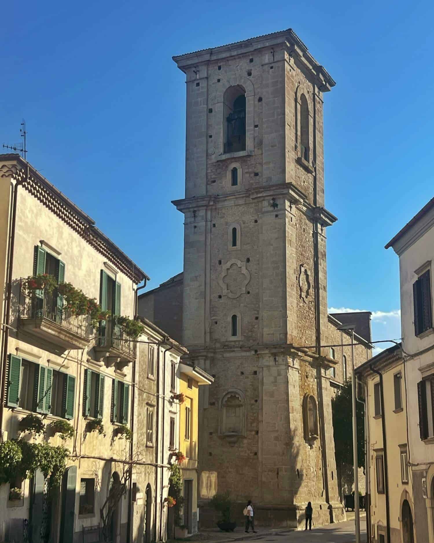 A church tower against bright blue sky in Agnone