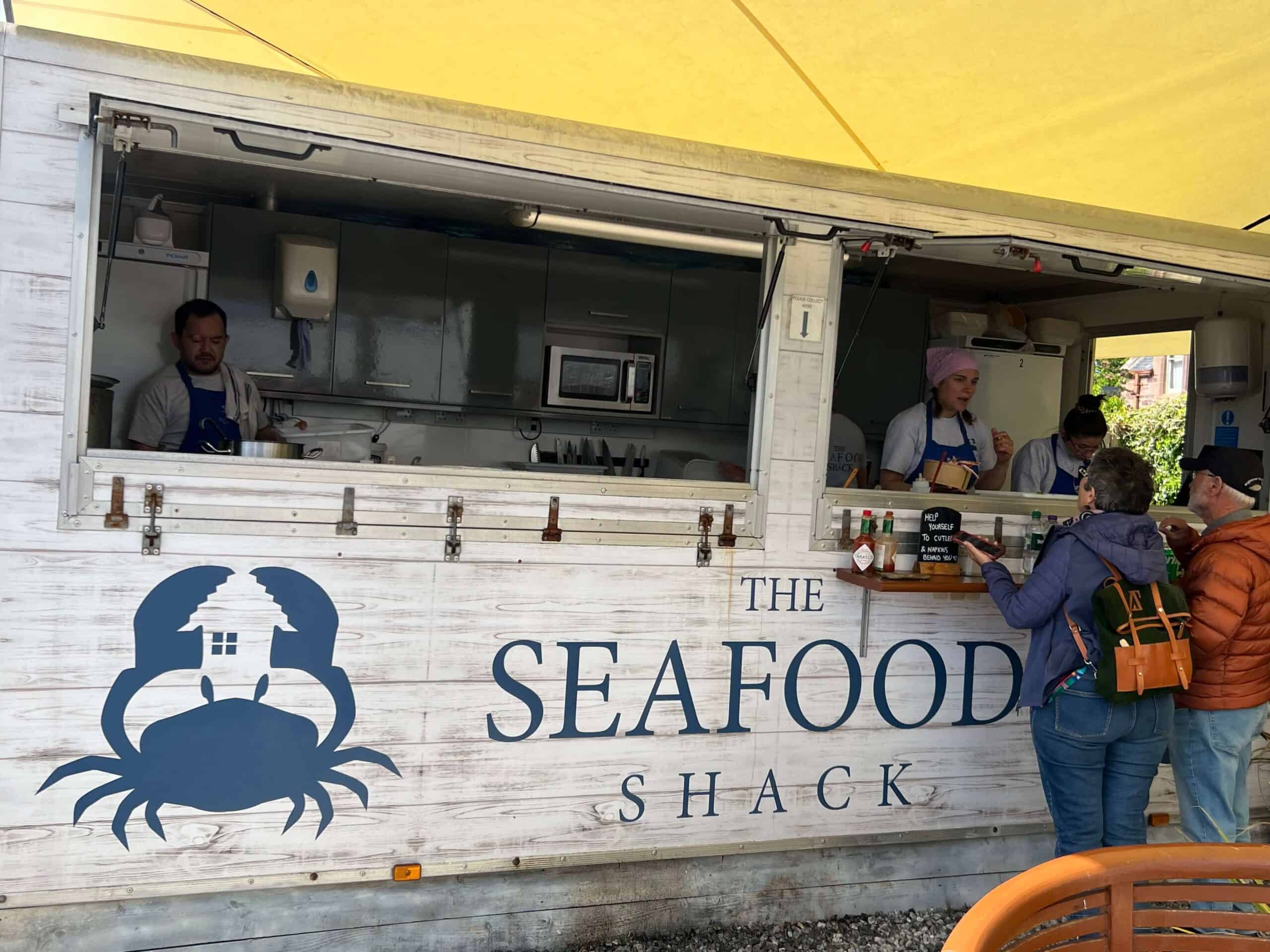 A couple ordering food at The Seafood Shack in Ullapool