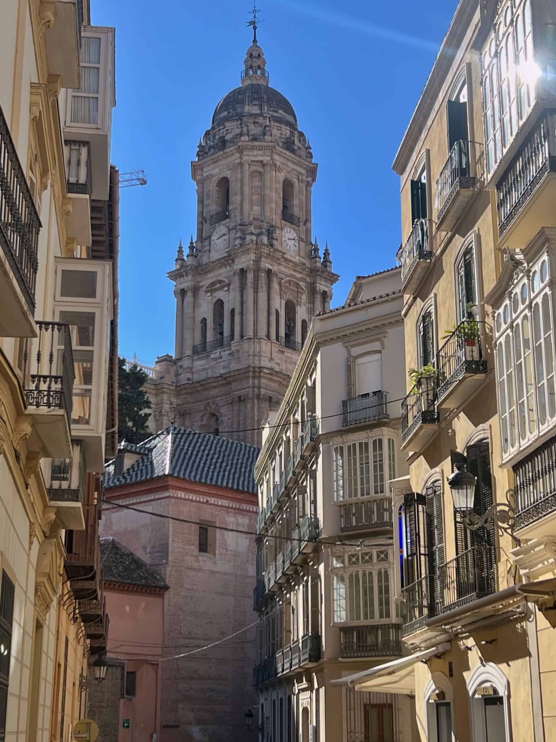 Malaga old town with narrow streets and a church tower 