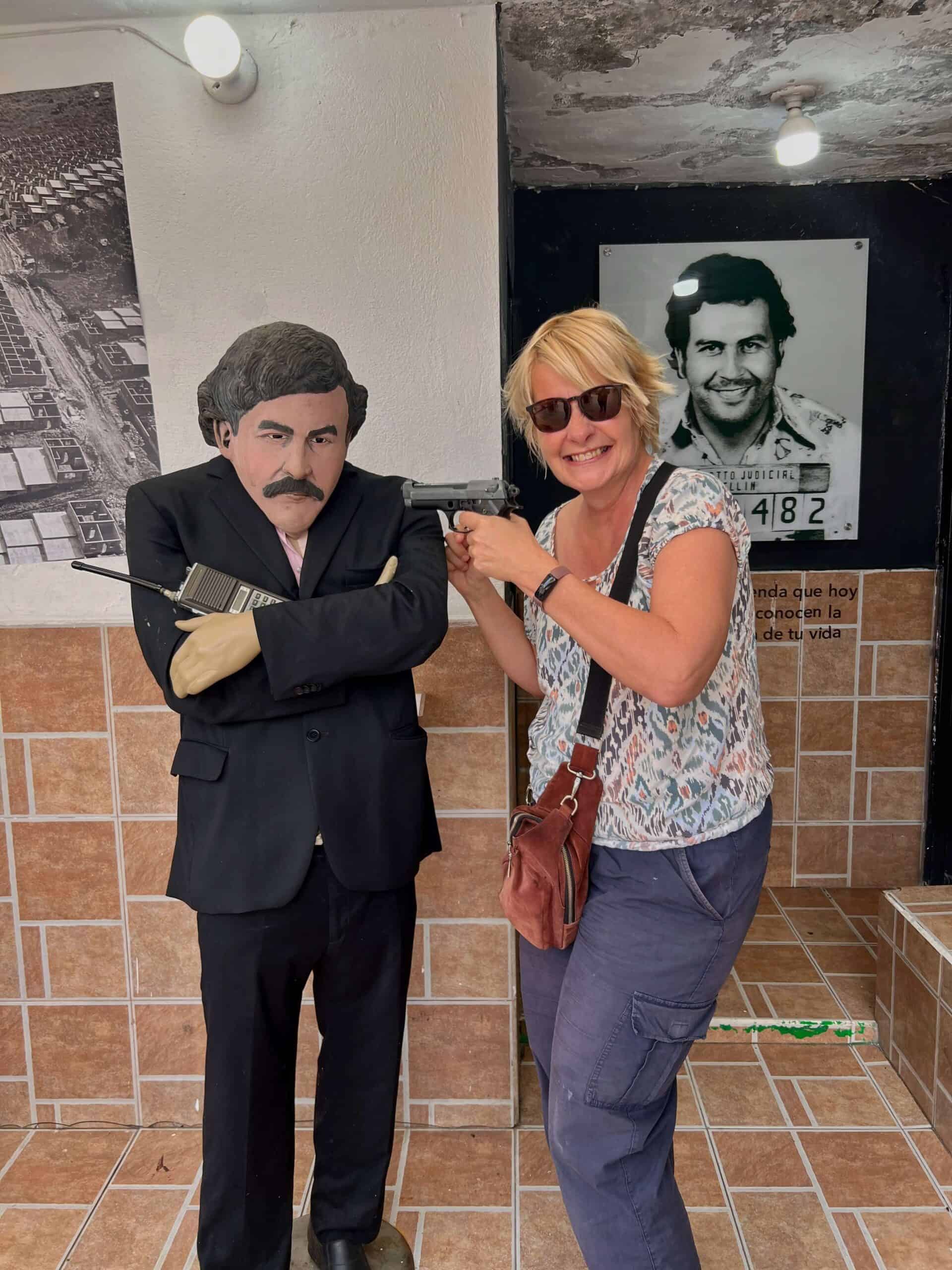 standing next to a wax figure of Pablo Escobar 