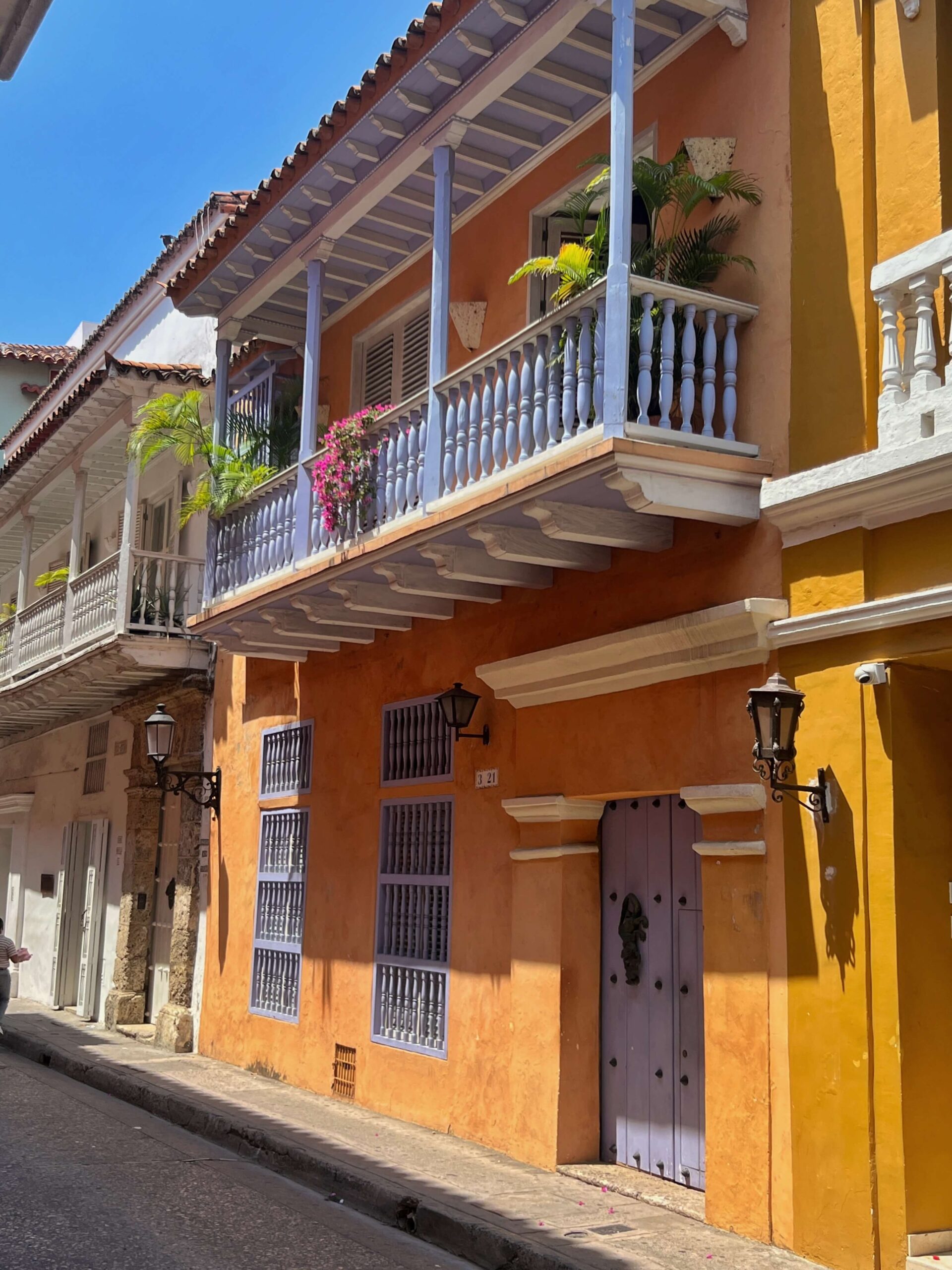 orange house with blue doors and balcony in Cartagena